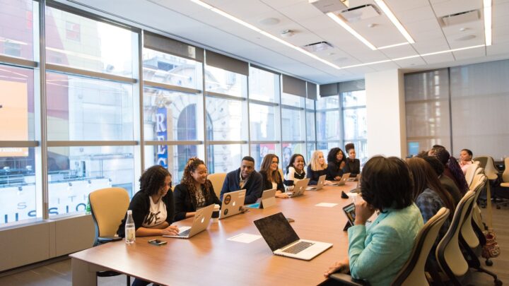 A diverse team of business professionals collaborating in a modern meeting room.