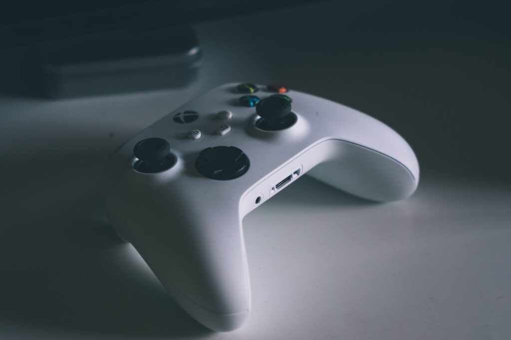 A detailed shot of a white gaming controller on a desk surface, perfect for tech and gaming themes.