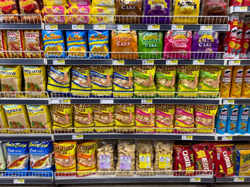 ultra-processed foods supermarket shelf variety colorful packaging