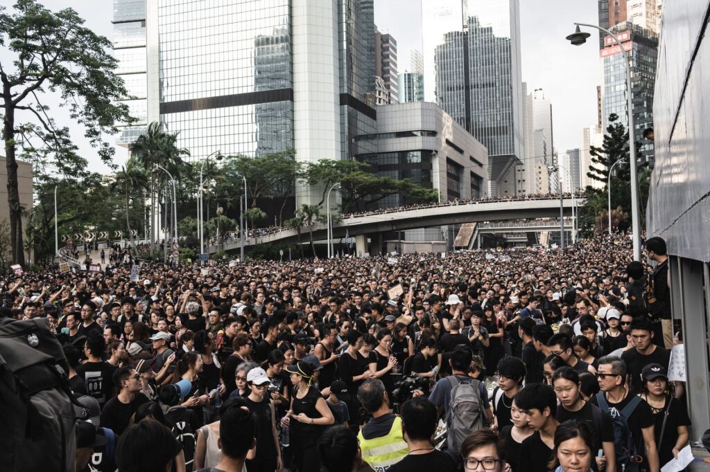 Crowd of protesters in Hong Kong's city streets demanding social justice and change.
