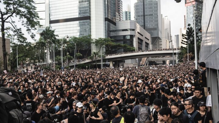 Crowd of protesters in Hong Kong's city streets demanding social justice and change.